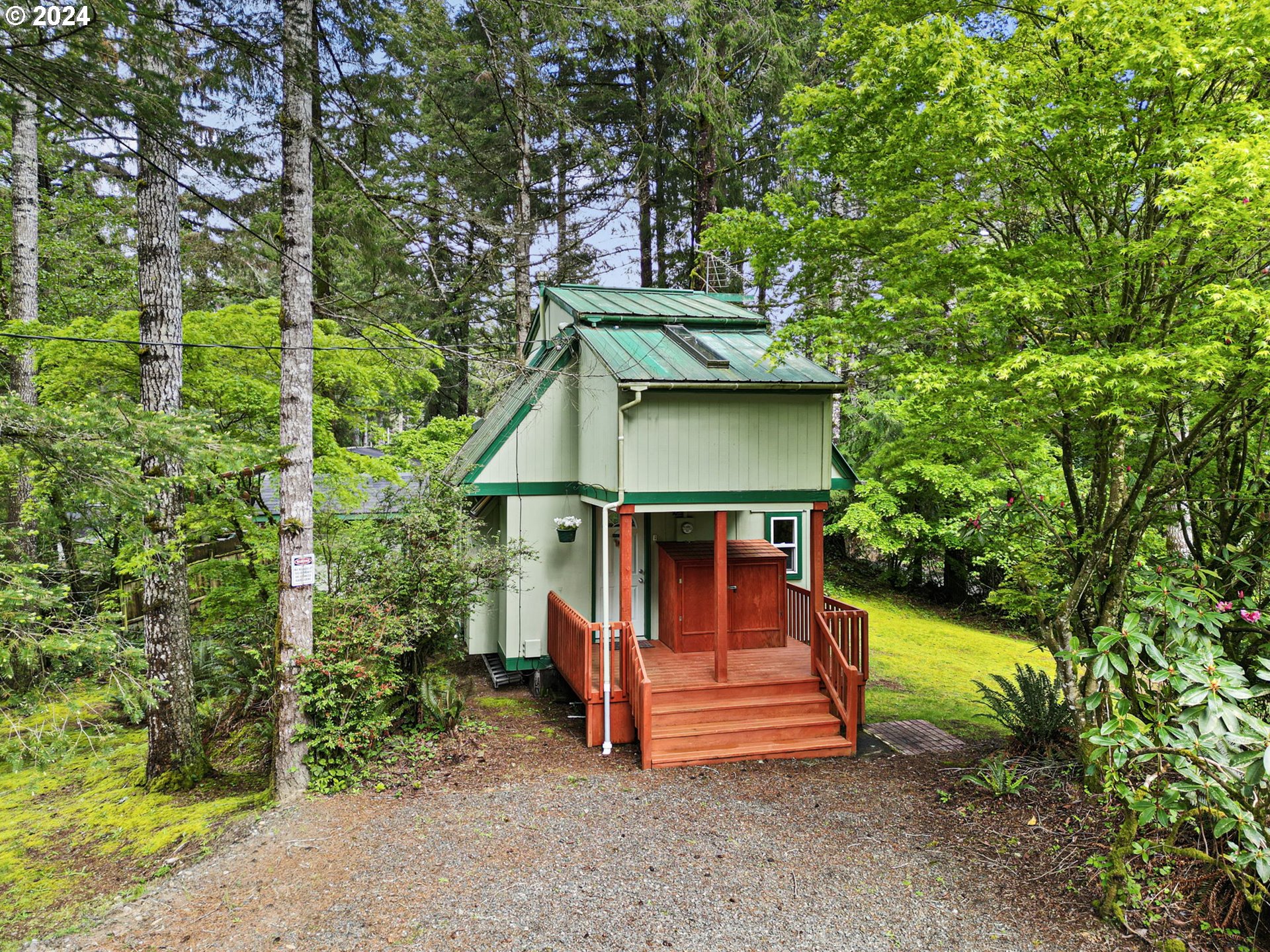 Your contemporary architect-designed cabin nestled in the woods sounds like a serene escape. The proximity to both the lake and beach offers a variety of outdoor activities, from leisurely strolls by the water to invigorating hikes through the forest. The sunny corner lot ensures ample natural light flooding into the cabin, highlighting the beauty of its all-wood interior, exposed beam ceilings, and the natural surroundings. The addition of skylights enhances the feeling of openness and connection with nature, bringing the outdoors in.A private yard with a fire pit provides the perfect setting for cozy evenings spent under the stars, gathered around the crackling flames with loved ones. It's a haven where you can unwind, recharge, and create lasting memories amidst the tranquility of the wilderness.