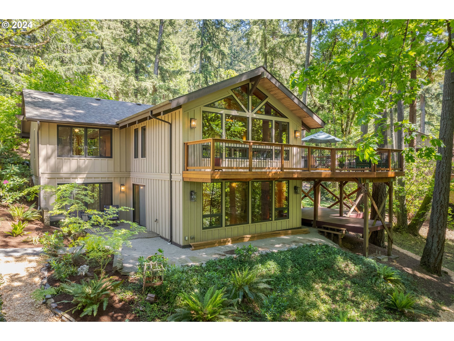 True craftsmanship abounds in this beautifully updated and immaculately maintained NW Contemporary on a 3/4 acre property in the SE Hills of Eugene! You'll love the incredible forested view from the vaulted living room w/ wood beams and wood burning fireplace. High end, custom-designed kitchen w/ honed granite counters, stainless appliances and cherry cabinetry w/ pullouts and soft-close doors opens to window-lined dining room and cozy sunroom w/ skylight. Rounding out the main level is the primary ensuite bedroom with walk in closet and fully remodeled bathroom featuring dual vanity and walk-in tile shower. The lower level offers multi-generational living opportunities with 2 more bedrooms, another full bathroom and a beautifully appointed family room featuring wetbar, custom cherry cabinetry, certified wood stove and slider leading to a private patio. Appreciate the outdoors and enjoy al-fresco dining on the sun-dappled deck or wander along the paths and in your own private forest retreat. Other features include Porte Cochere drive-thru carport and driveway, ample parking for RV or trailer, tons of storage, wood-framed Marvin windows, newer furnace and a/c, and so much more. Completely move-in ready with clean inspection on file. Perfect for the buyer who appreciates uncompromising quality!