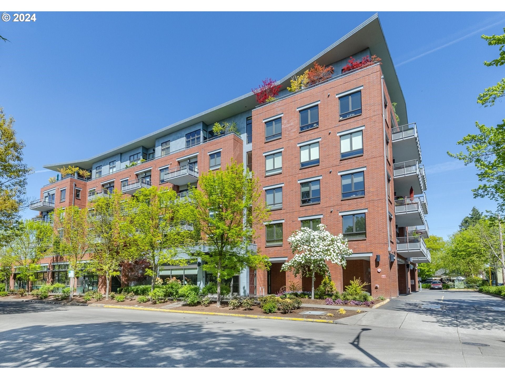 The Tate is a 46-unit, elegant post-tension concrete and brick-veneer building developed by six forward-looking women who dreamed of urban living in community. Close to all the amenities that the downtown location offers. The developers created a warm welcoming environment with maintained garden/patio space and inside cozy meeting spaces for weekly events and gatherings. This unit was completely updated with new interior paint, refinished engineered hardwood floors and new wall to wall carpet in the bedrooms. The fully appointed kitchen includes a gas range, new stainless steel dishwasher and free standing stainless steel refrigerator. There is a full size pantry and granite tile counters with a floating kitchen island. Washer and dryer are included in the utility room with additional storage. The high ceilings give a sense of spaciousness and ample east facing window provide plenty of light. Unique to this unit is the 280 sqft patio, one of only 4 units in the building. There is one deeded parking space and storage unit included. Security of the building is a priority, with front door key fob, secure, gated parking, exterior and interior video monitoring. Come have a look at this unique, sought after unit.