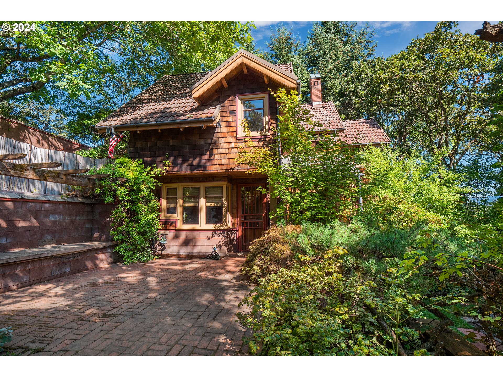 Built by local Architect Rob Thallon, This home was the very first house built in Spyglass and has one of the nicest and largest lots in the entire neighborhood. Every inch of this home is intricately detailed with a cozy fireplace, sun room, pantry, Italian Tile floors in kitchen/dining area. Great storage space with lots of hidden cubbies throughout. Views from each window, private back patio with views of the mountains and golf course. Rob Thallon, previous Dean of Architecture for the University of Oregon, now professor emeritus, architected and oversaw the building of the house.  The custom build was modeled after a European architectural style observed after the original owner's visits to Europe. Because the owner of the house was also the owner of what became the Oakway Golf Course, she had first-pick in terms of location and orientation, with a spectacular view of the golf course in an extremely quiet area.  In summer, because the golf course is watered regularly, and because of the tree coverage, it remains a good 10 degrees or so cooler in the yard than in surrounding areas. The house is nestled deeply away. No one can see inside the house from the street, so it is very private and the location is unbeatable with close access to shopping, healthcare, restaurants, Downtown and I-5. This house is 1 of 4 houses with common area access located directly below the house, above the golf course. The common area is unique in that the owner of 504 Spyglass may use the common area or even improve it as desired, which is a great benefit to the property.  Additionally, no houses can be built in the common area, so the house will always have a spectacular view of the golf course. The home is made of very fine materials with excellent craftsmanship and woodwork throughout. The high-quality clear Doug Fir wood used throughout the interior can no longer be sourced. Rebuilding this home today would be a multi-million dollar venture. This is a must-see home.