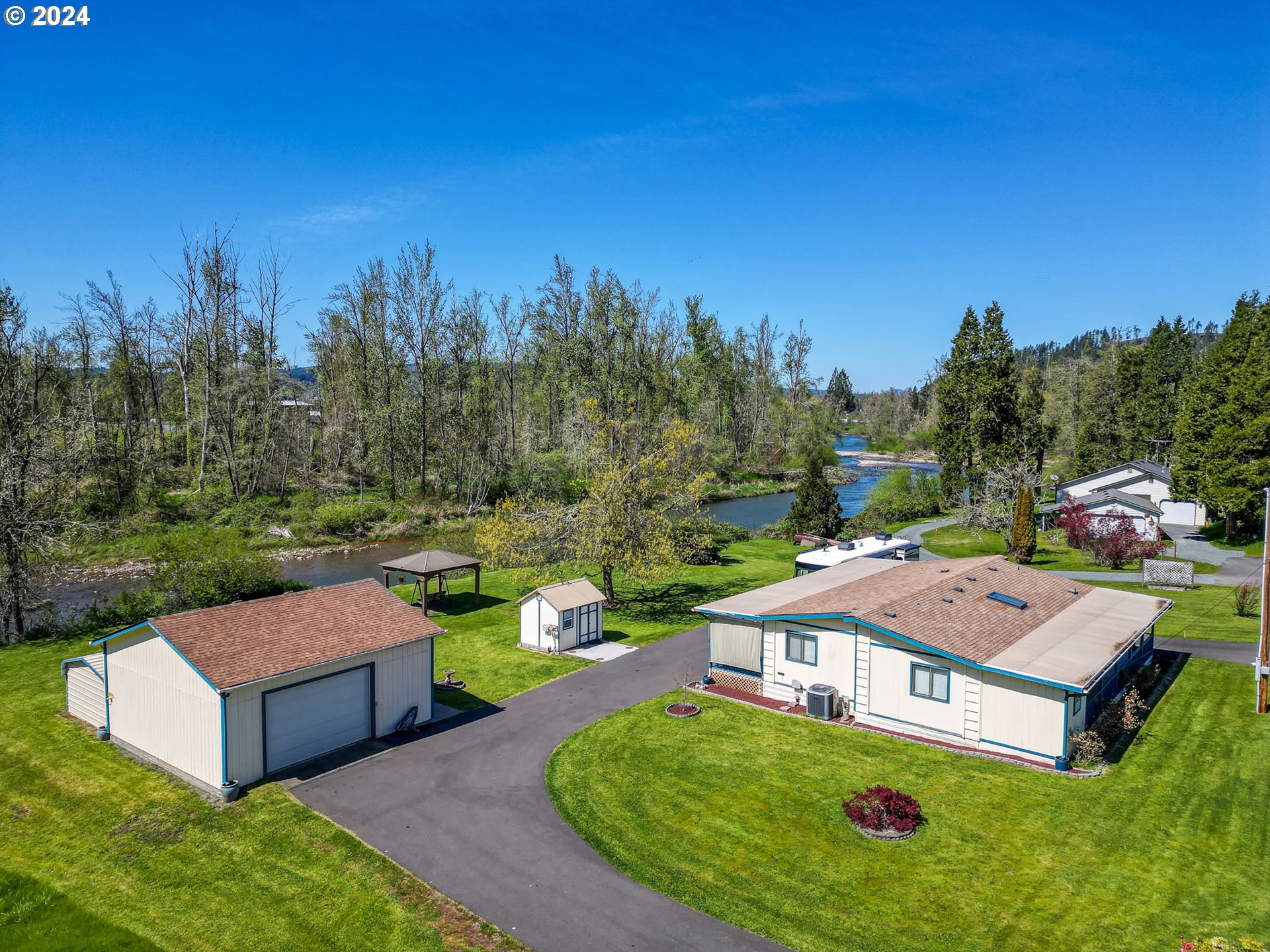 Don't miss this serene retreat with Row River frontage, where you can fish from your own backyard and enjoy the peaceful sights of herons, eagles, osprey and other wildlife. The large covered porch and gazebo by the river offer fantastic spots for relaxation and taking in the beauty of your surroundings. Pride of ownership is evident throughout the property with the well maintained home, large shop space and lovely grounds.  The fully insulated garage/shop with power adds practicality and versatility, while the new $30k driveway ensures ample parking space for all the vehicles including the RV with hook-ups.  This property is a special place where one could truly unwind and enjoy the tranquility of nature.  Open House 4/20 12-2pm, 4/21 12-2pm