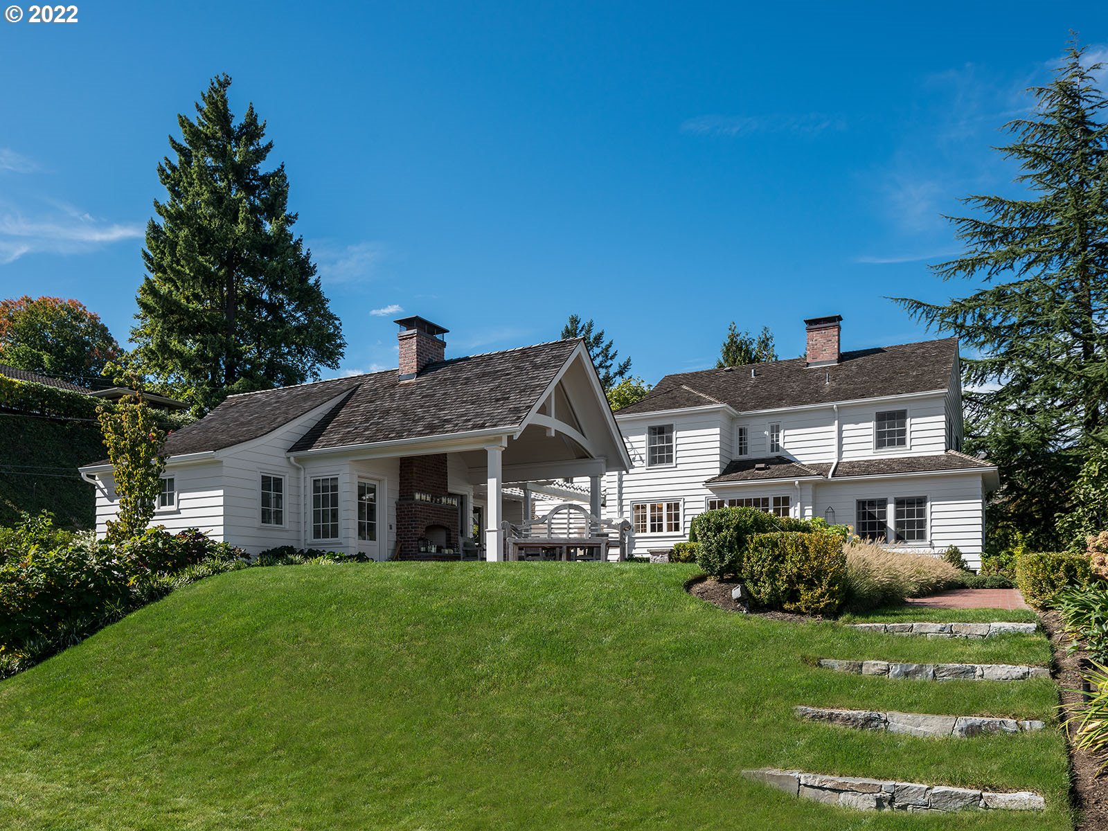 Stunning traditional home effortlessly blends the timeless charm of the 1930s with the conveniences of modern living. Located on a rare, double lot in the coveted Portland Heights neighborhood, this property offers incredible views of the city skyline and Mt. Hood.The beautifully remodeled kitchen provides a perfect space for both cooking and entertaining, with sweeping views that will leave you in awe. The spacious primary suite, along with three additional bedrooms upstairs. The large basement family room offers additional space for recreation or relaxation.Step outside into your private oasis, complete with a meticulously landscaped yard and an outdoor fireplace, ideal for entertaining year-round. A detached 769 sq. ft. guest house, featuring its own bedroom and bathroom, offers comfort and privacy for guests or additional living space.A truly one-of-a-kind property.