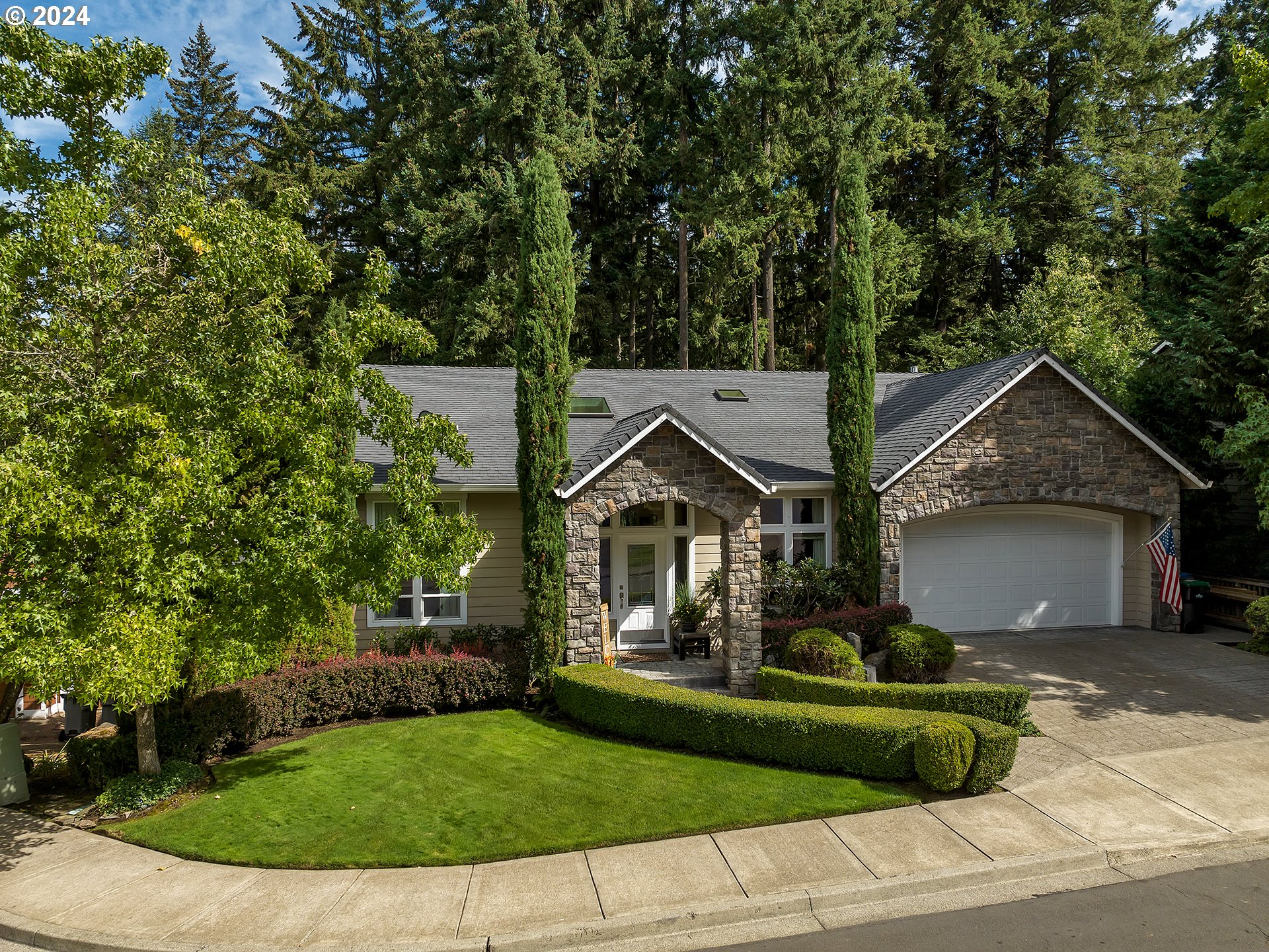 Nestled in the desirable Bull Mountain area of Tigard, this expansive home lives like a one level, and features a daylight basement you’re sure to love! The main level boasts beautiful Brazilian cherry hardwood floors, vaulted ceilings, and intricate millwork that elegantly elevates the space. Skylights flood the home with natural light, highlighting the flow between the formal dining area, spacious great room, and large kitchen. The kitchen, featuring ample cabinetry, stainless steel appliances, a cozy dining nook, and opens seamlessly to the back deck, perfect for peaceful outdoor living and entertaining. The master suite, located on the main floor, boasts a huge walk-in closet, a spa-like bathroom with a jetted soaker tub, a walk-in shower, double sinks and spectacular picture window overlooking the forested backdrop. A home office with French doors, powder bath, and laundry room can also be found on the main level as well.Downstairs, you'll find four spacious bedrooms, one of which is a bedroom suite, a family room with a sliding door to another spacious deck, a kitchenette, a large storage room, and an additional bathroom. Very accommodating for those who may also be seeking multi-generational living.Outside, enjoy the peaceful privacy of the expansive green space and wooded territory, along with great location near top schools, parks, and all the amenities Tigard has to offer, this home presents a rare opportunity to enjoy luxury and convenience in a coveted setting.