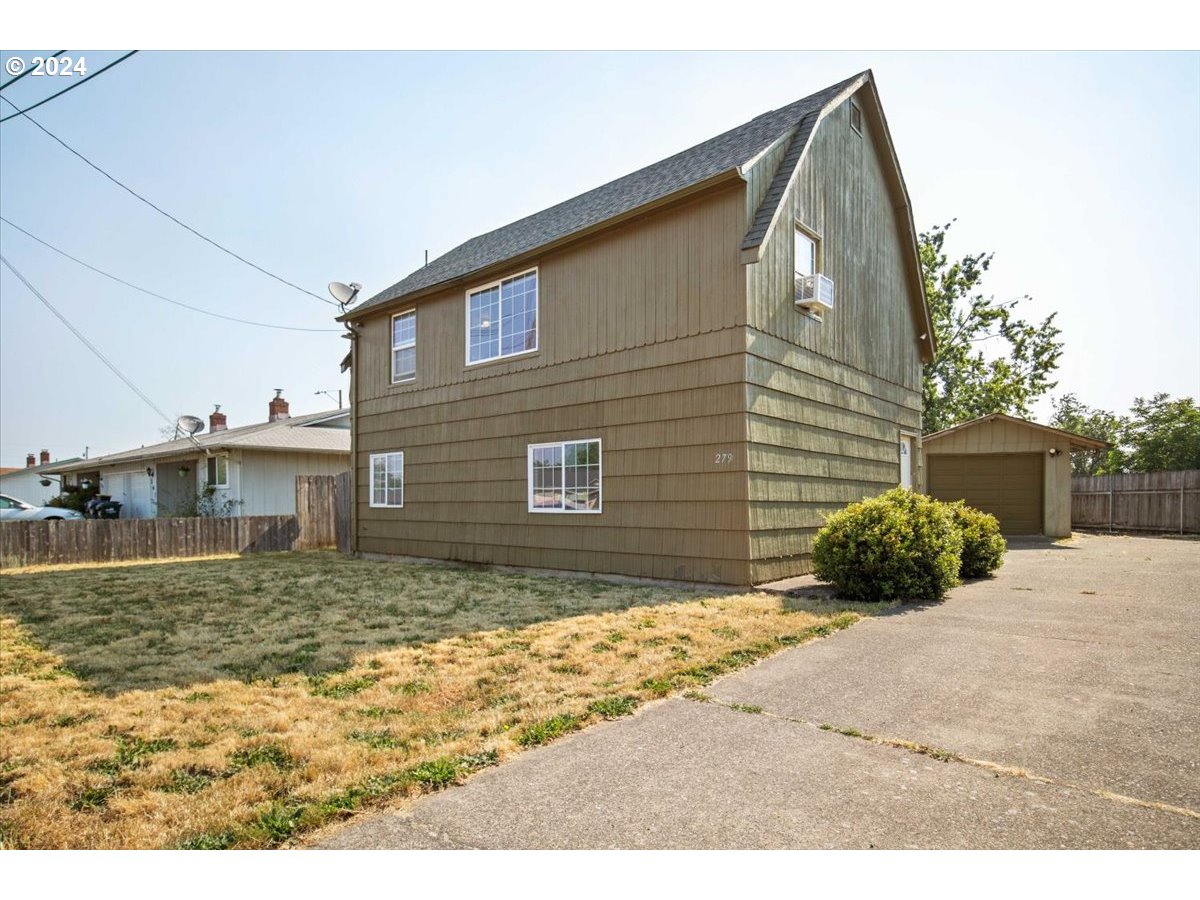 This home offers great separation of space, with two bedrooms, 1 bathroom and living area on ground floor.  Upstairs is the primary en-suite, a second living area and kitchen.  Small deck off the primary bedroom overlooks the fenced and spacious backyard. Detached one car garage has plenty of space for storage or hobbies. This home is move-in ready, but also is prime for updates to match your specific taste.