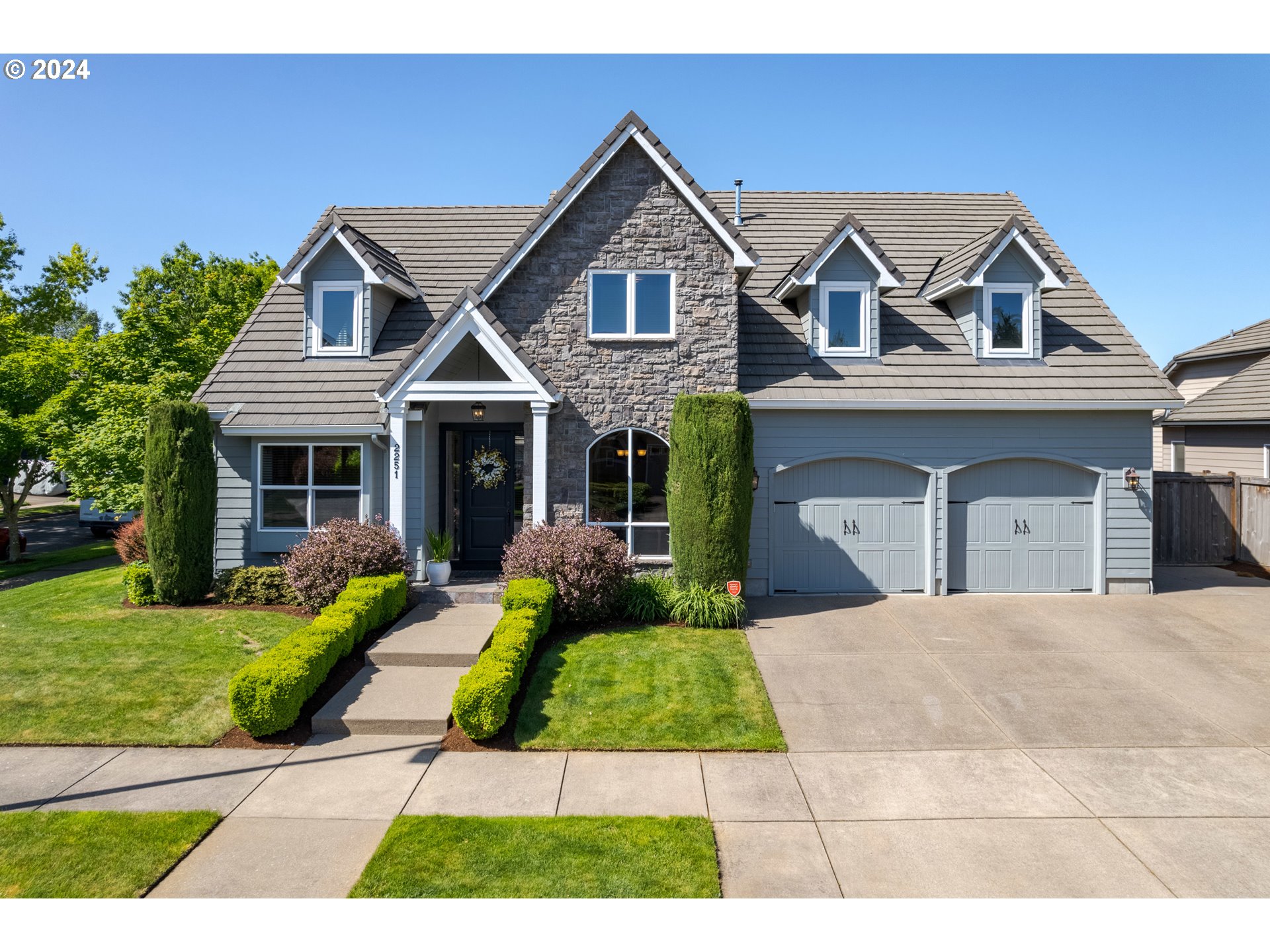 Timeless design & finishes plus quality craftsmanship in this immaculately maintained 1-owner home on a corner lot in quiet North Gilham neighborhood! Upon entering, you will be captivated by the 18-foot ceilings and gleaming brazilian cherry floors, spacious great room w/ gas fireplace, gourmet kitchen w/ electrolux 6-burner gas range, double wall ovens & fridge plus an eating bar and pantry. Main level private primary ensuite with soaking tub, dual sinks, walk-in shower, huge walk-in closet and a slider leading out to the back patio. Main level also features formal dining/sitting room, office/4th bed plus powder room and utility room with sink & storage. The light-filled stairway leads to an open catwalk, quaint reading nook, 2 more bedrooms and a spacious family room with wet bar that would work perfectly for a guest space. The fully-finished 3 car garage (713 sqft!) offers ample storage and the RV pad is perfect for a utility trailer or boat. Outside you'll love the feeling of privacy in your fully fenced, easy to maintain yard with spacious patio and underground sprinklers and soon the lilies and hydrangeas will be blooming in your perennial garden. Call your agent today to view this lightly-lived, well-built home!