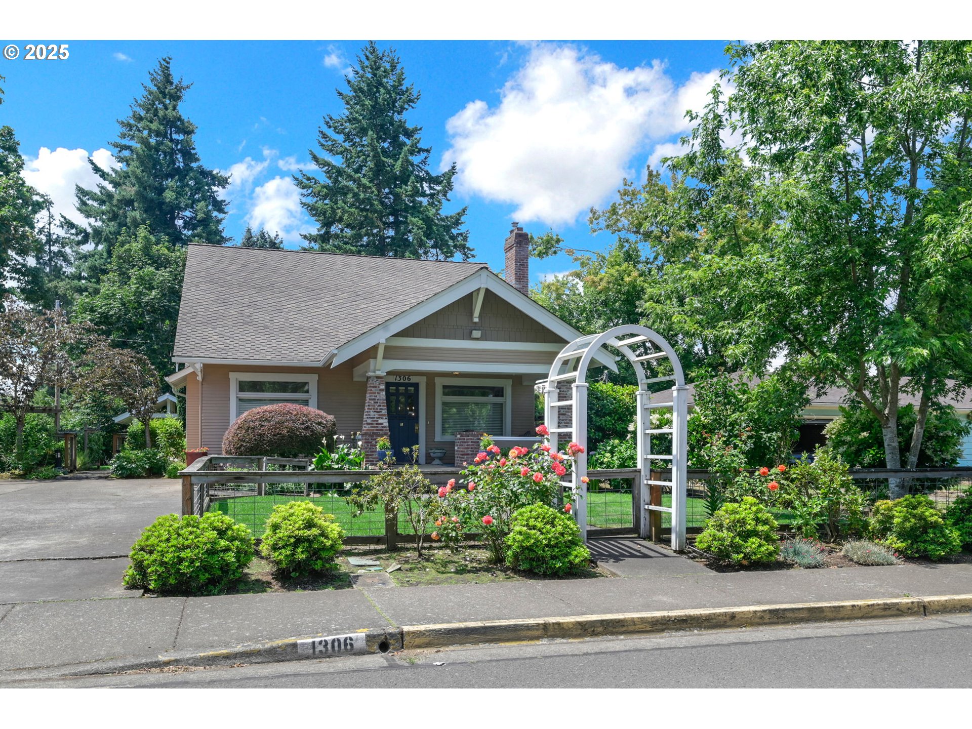 This beautifully restored 1918 Craftsman blends timeless character with subtle updates for everyday comfort. Careful attention to period details is evident in the formal living and dining rooms, while the kitchen features granite countertops and gas appliances that complement the home's charm. The primary suite on the main level.The inviting family room opens through French doors to multiple patios, perfect for relaxing or entertaining. Set on a lush .35-acre lot, enjoy vibrant gardens filled with blueberries, raspberries, fruit trees, herbs, and roses, plus a covered barbecue area. A detached three-car garage includes a large bonus space, ideal for a home office, studio, or hobby business. A rare opportunity to own a thoughtfully preserved piece of history.