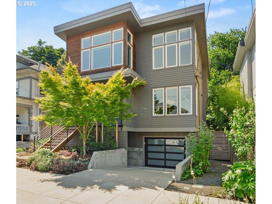 Open House Friday, June 27 from 4–6 PM – hosted by Listing Agent. Modern Comfort in a Walkable, Bikeable NE Portland Location! Built by Everett Custom Homes and Certified Earth Advantage, this lightly lived-in home offers the perfect blend of style, sustainability, and location. Sunlight pours through large windows, illuminating the open concept design with engineered hardwood floors, sleek metal railings, built-ins, and serene territorial views. The gourmet kitchen is a showstopper with a slab waterfall quartz island, Ann Sacks tile, induction range, stainless steel appliances, walk-in pantry, eating bar, and generous dining space—ideal for entertaining. Cozy up in the living room by the gas fireplace or retreat to the spa-like primary suite with soaking tub, tiled shower, dual sinks, barn doors, and walk-in closet. The lower-level bonus room with adjacent full bathroom is perfect for media, guests, a home gym, or a fourth bedroom. Enjoy year-round outdoor living on the front porch or large covered back deck with gas BBQ hook-up. The private, fully fenced yard offers ample space to grow your dream garden. EV-ready 2-car tandem garage. Commercial-size washer and dryer. For your convenience, all appliances are included. Located on a designated greenway street, a dream for bikers—with car-lite convenience and access to Portland’s best bike routes. Fiber internet ready, privacy glass in key locations, 9’ ceilings on the main level, french doors, and 4 dog-friendly parks nearby. Just minutes to Alberta Arts, N. Williams, Mississippi, restaurants, food carts, bakeries, breweries, shops, the farmer’s market and so much more! Walk Score 92. Bike Score 93. Buyer incentives negotiable—schedule your tour today and fall in love with this exceptional home! [Home Energy Score = 9. HES Report at https://rpt.greenbuildingregistry.com/hes/OR10176786]