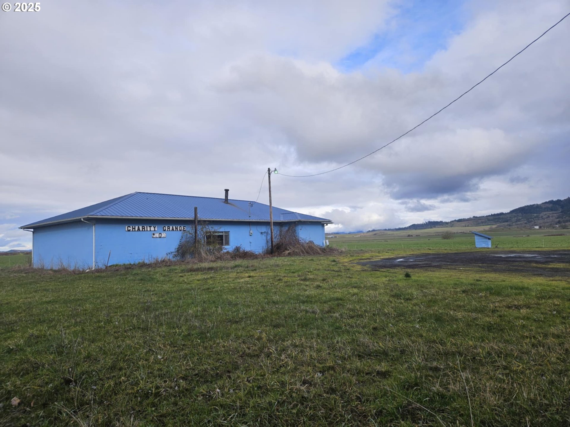 Existing building is 2,964 square feet with very large main room, large kitchen, bathrooms on .86 acres of land with mountain and valley views. EFU Agricultural Zoning allows for a variety of related businesses. Buyers to do their own due diligence regarding options for use of this property.