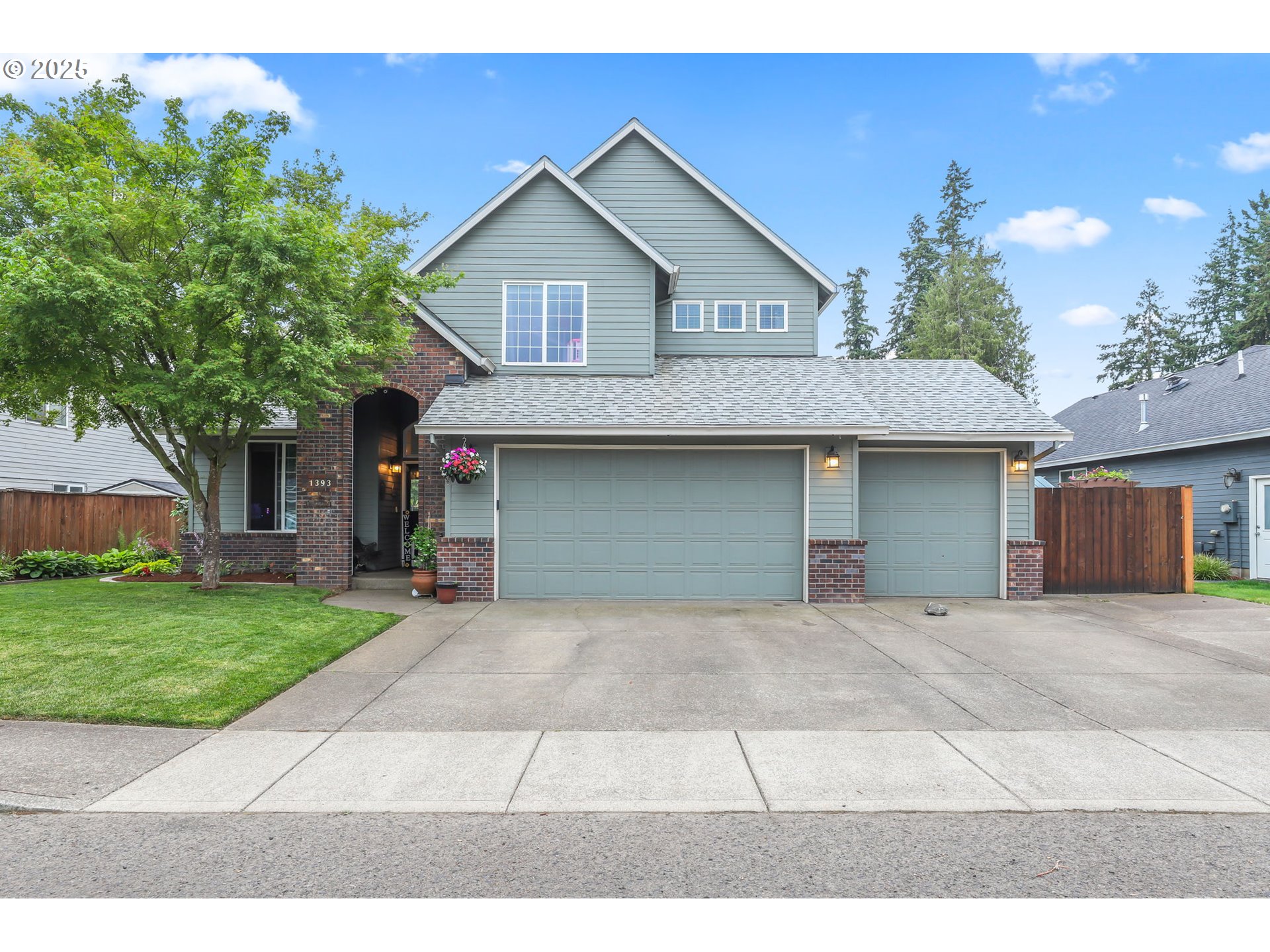 Beautifully maintained and truly move-in ready, this spacious home is located in a desirable and easily accessible Canby neighborhood. Offering flexibility with 4 bedrooms—or 3 bedrooms plus a main-level office with French doors—this home features a bright, open floor plan with vaulted ceilings and expansive windows that frame views of the lush, landscaped backyard.The gourmet kitchen is a chef’s delight, complete with abundant cabinetry, stainless steel appliances, a cook/eating island, and a pantry. A large utility room with sink and washer/dryer (gas) included adds convenience. The inviting family room boasts vaulted ceilings, a cozy gas fireplace, and a wall of windows overlooking the serene backyard. The adjacent dining area opens to the patio through elegant French doors.Upstairs, the spacious primary suite offers a walk-in closet, coved ceilings, a ceiling fan, and a luxurious spa-like bath featuring a soaking tub, separate shower, and double sinks. Two additional well-sized bedrooms and full bath complete the upper level.Step outside into your private backyard oasis—fully fenced and thoughtfully designed with a patio and retractable awning, raised garden beds, mature landscaping, sprinklers (front & back) a kids' play area, and a storage shed with power.  New roof 2021.The oversized 3-car garage provides ample parking and storage, while an expanded driveway and extended fence allow for secured small RV, boat, or toy parking inside the gate.Located directly across from Canby’s scenic 4-mile walking/biking trail to the river, this exceptional home is the perfect fit for family living and outdoor enjoyment.