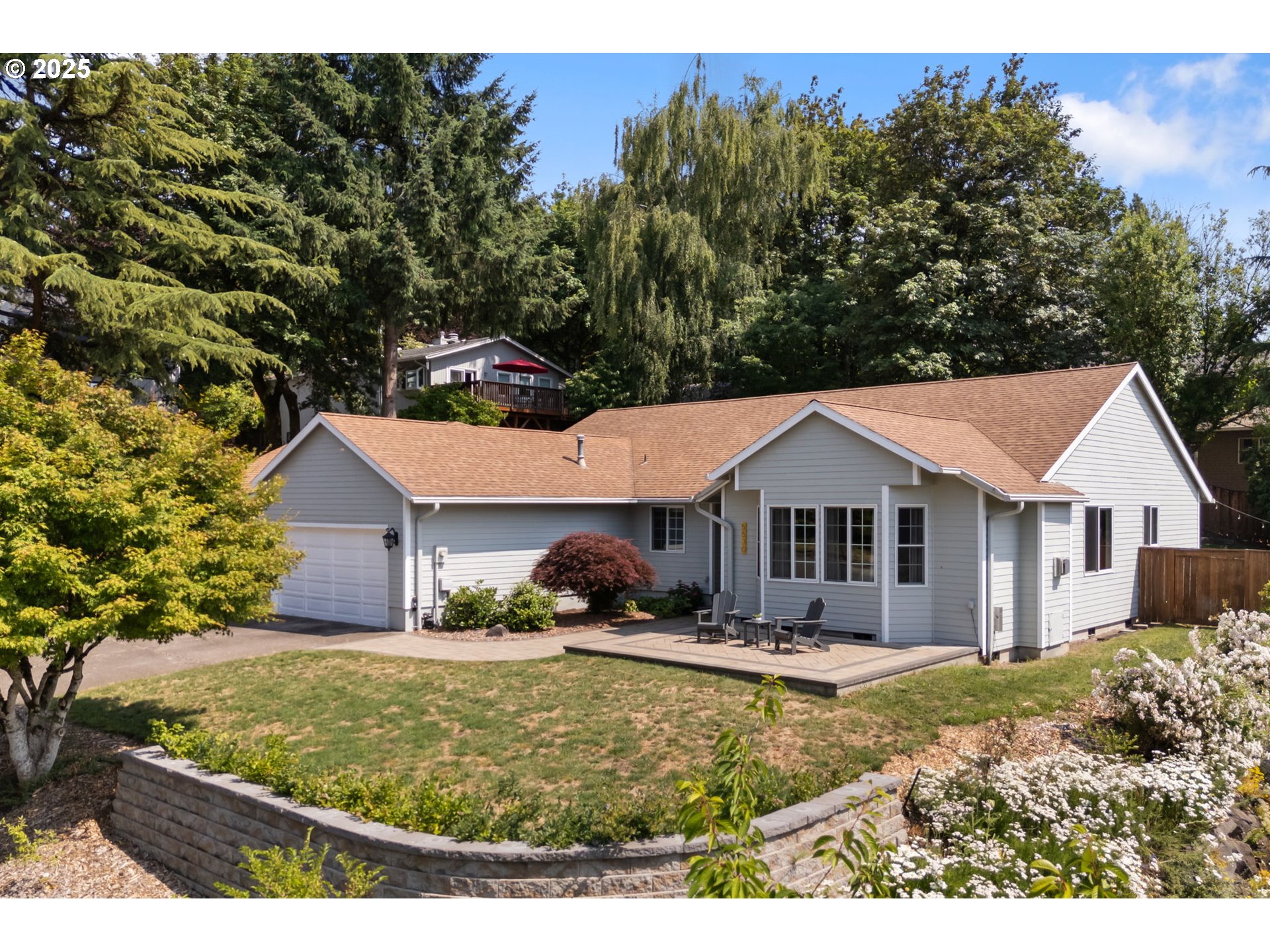 Blueberry lover’s paradise! Sitting at the top of a quiet cul-de-sac, tucked just behind PCC’s Sylvania campus in SW Portland, this single-story home offers space, style, and convenience in one beautiful package. Inside, enjoy a fantastic open floorplan with flexible living areas, vaulted ceilings, and brand new luxury vinyl plank flooring throughout the main living space.The beautifully updated kitchen features new cabinets, quartz countertops, and stainless steel appliances—opening seamlessly to the great room for easy entertaining. The vaulted primary suite includes double sinks, a jetted tub, and walk-in closet. Updated bathrooms, newer roof, HardiePlank siding, and Anderson windows (all 2008) ensure peace of mind. Additional highlights include central air, a newer furnace, a smart garage door opener, smart irrigation system, and a spacious 3-car garage with attic storage above.The fenced backyard includes 25+ productive blueberry bushes, a back patio (2018), and a newer front patio and retaining wall (2023). LeafGuard gutters come with a lifetime warranty. Exceptional location with walking and running routes, bus stops, and Barbur Transit Center nearby, plus easy access to I-5, Hwy 217, downtown Portland, Lake Oswego, and Wine Country.