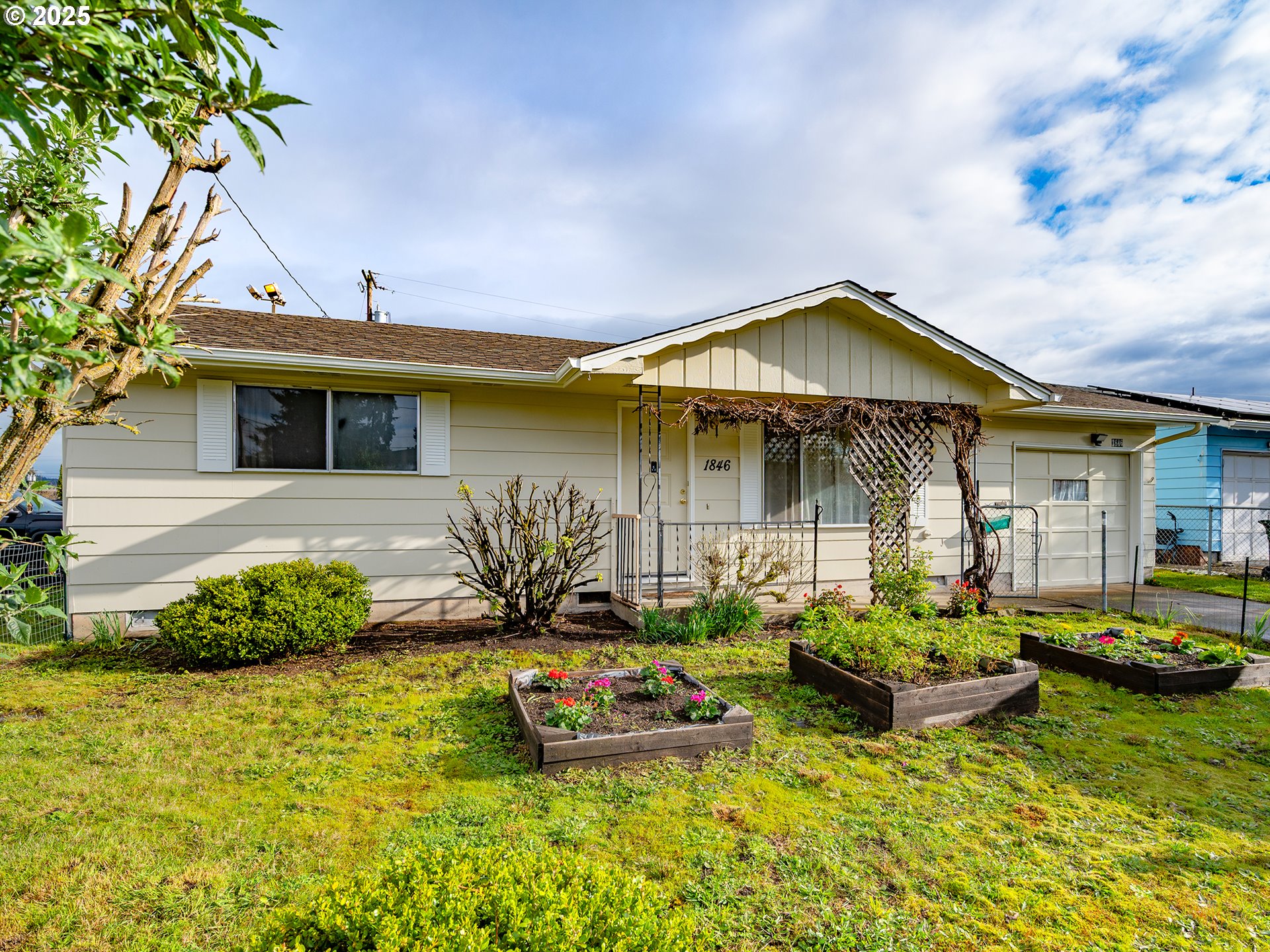 Why wait? This well-kept starter home offers comfort, convenience, and potential—all at a great price. Looking for the perfect one-level home to comfortably age in place?This thoughtfully designed home supports long-term comfort with just one step at the entrance, one step to the backyard, and one step to the garage—minimizing barriers as mobility needs change. With all living spaces on a single level, it offers a safe, accessible layout ideal for maintaining independence. Whether you're planning ahead or ready to simplify your lifestyle, this home is designed with your future in mind. Step into a bright, spacious living room with wood floors and large windows. The two bedrooms also feature wood flooring, and the kitchen is warm and inviting with solid wood cabinets in excellent condition. A one-car garage and a 15x11 shop/storage area add flexibility and function.Enjoy the sunny front yard with raised garden beds, and a generous backyard ideal for gardening, play, pets, or adding onto the home.Located just a short walk or roll to daily essentials—bus stops, grocery stores, medical offices, hardware, parks, and more. The roof is only 5 years old, and the exterior was recently painted.