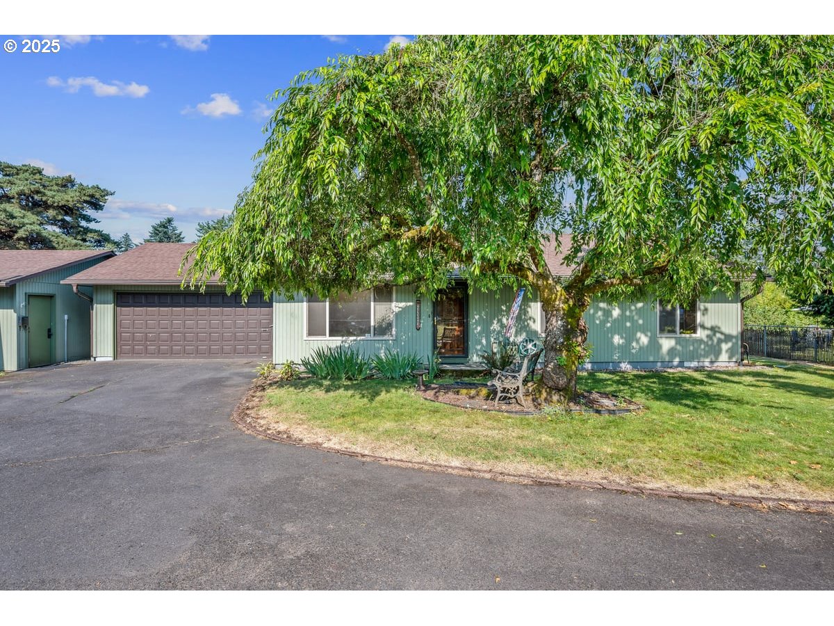 This is one of those rare opportunities when you find a home that has been lovingly cared for with pride of Ownership PLUS it has an amazing detached second garage/shop/studio (approx 23x21). Drive down the driveway to discover this private, retreat like space. The solid one level home has Shaw brand hand scraped engineered hardwood "Hickory" flooring in the living, dining, and hall with new carpet in the bedrooms. Freshly painted interior, too! Carrier Heat Pump, new electric panel in the house, and newer vinyl double pane windows.  Kitchen includes all stainless steel appliances plus there are pull outs in the lower cabinets. Washer/dryer in the laundry room stays. Fenced yard includes blueberry and raspberry bushes, apple and pear trees. Both the attached garage and the shop are fully sheetrocked, textured and painted. Shop has power (no water) plus two full size garage doors for easy access. Loads of built-ins and lighting. As if that isn't enough, there is an extra high covered carport area for storage of RV's or any number of toys. [Home Energy Score = 1. HES Report at https://rpt.greenbuildingregistry.com/hes/OR10239296]
