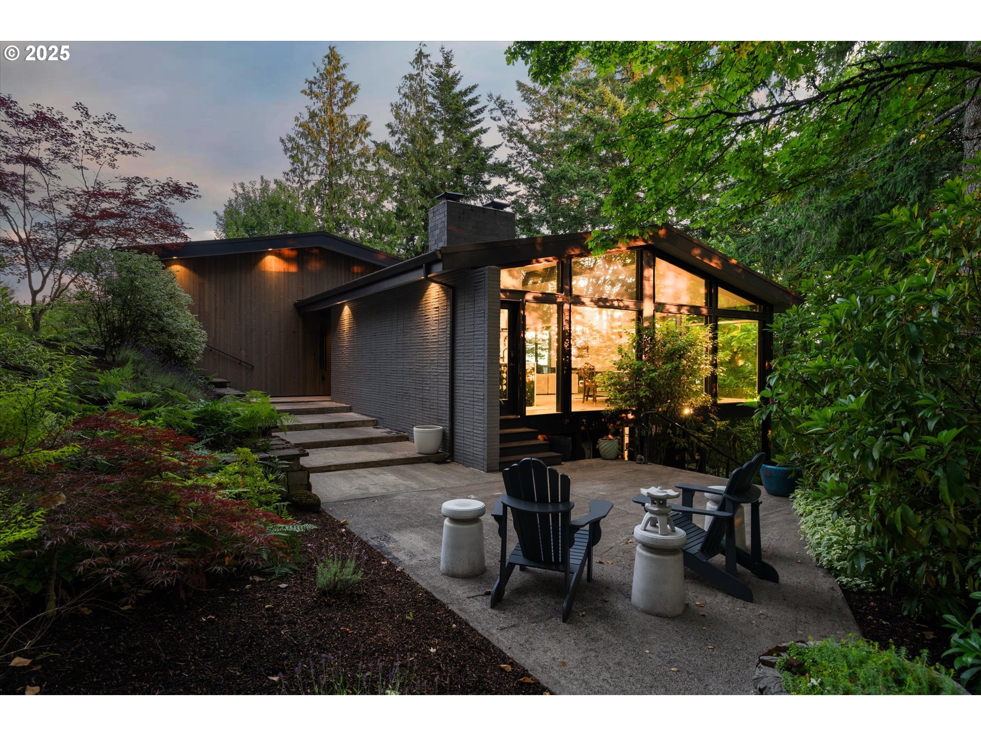 This updated 1962 mid-century modern by architect Clive Kiehl is a true blend of artistry and function. Perched on a quiet street above the Forest Park Communities, the home offers striking southern and western valley views framed by expansive walls of glass and warm, natural surroundings.Remodeled to the studs in 2017 with close attention to design and detail, the residence features an open floor plan and floor-to-ceiling windows, anchored by a sleek chef’s kitchen complete with a 10-foot quartz waterfall island, and Sub-Zero, Wolf, and Miele appliances. The adjacent dining solarium and wet bar alcove create the feeling of dining outdoors.Vaulted ceilings, clean lines, and minimalist finishes carry the design ethos throughout. The primary suite is a private retreat with southwest views, a fireplace, and radiant heated bath floors. The flexible layout includes three additional bedrooms—each with private entries—a gym/media room, and a spacious separate studio perfect for creative work or guest quarters.Recent updates include a new laundry room on the lower level, a motorized pergola over the front patio, gutter guards, and a modern fireplace in the great room.With thoughtful smart wiring, artisan touches, and an unbeatable location just minutes from downtown, Nike, and Intel, this is a rare opportunity to own an iconic home reimagined for modern life.