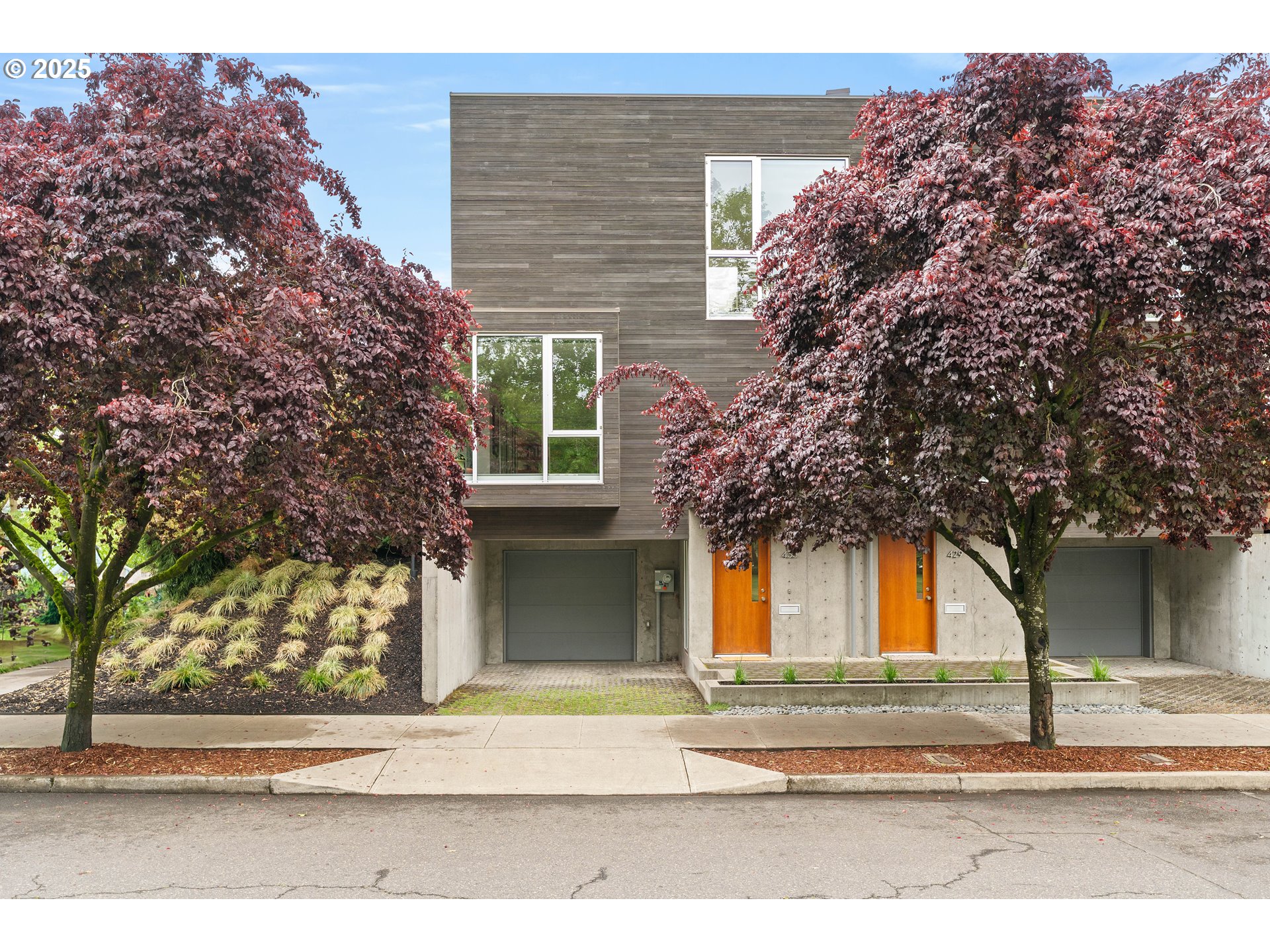 Introducing the Parkbox row house designed by local architect Corey Martin and winner of the AIA Craftsmanship and Merit awards. Northwest contemporary in design with its simple, natural palette while the south facing site orientation maximizes sunlight exposure with floor to ceiling windows, skylights and sliding glass doors connecting you to the outdoors at every turn. Custom interior featuring an open, functional floor plan and high end finishes. The unique floating staircase is suspended on steel rods that allow them to be open and connected to the main interior living space and create a stunning visual. The Park Box was designed for nature lovers in the city . A quote from an interview with the architect  "When you’re in here it feels like the best balance between urban and rural. You see the horizon, the green of the grass, the trees, the park. And the design of the windows is such that your view is guided upward."Featuring 3 bedrooms and 2.5 bathrooms with high ceilings on each level. The main level living room has oak flooring throughout, a built in window bench overlooking the park and a floating fireplace. The main level kitchen has open shelving with a glass tile backsplash, quartz counters,  stainless gas range, a wall of sliding glass windows + doors that connect to the private outdoor deck space surrounded by established landscaping. The upper level has 2 bedrooms, a full bathroom and a flex loft space for an office or light filled lounge space. The lower level has a bedroom, a full bathroom, a landing area and connects to the tuck under garage. Beautiful natural wood and concrete exterior with landscaping on a corner lot. Located across from Unthank Park in the heart of the thriving Mississippi-Williams corridor with so many local restaurants and shops just minutes away to choose from. [Home Energy Score = 8. HES Report at https://rpt.greenbuildingregistry.com/hes/OR10237851]